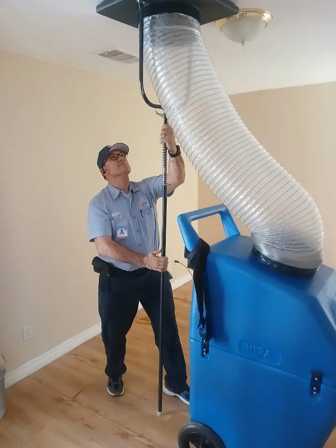 Furnace Tune-Up technician using HEPA equipment in Gainesville